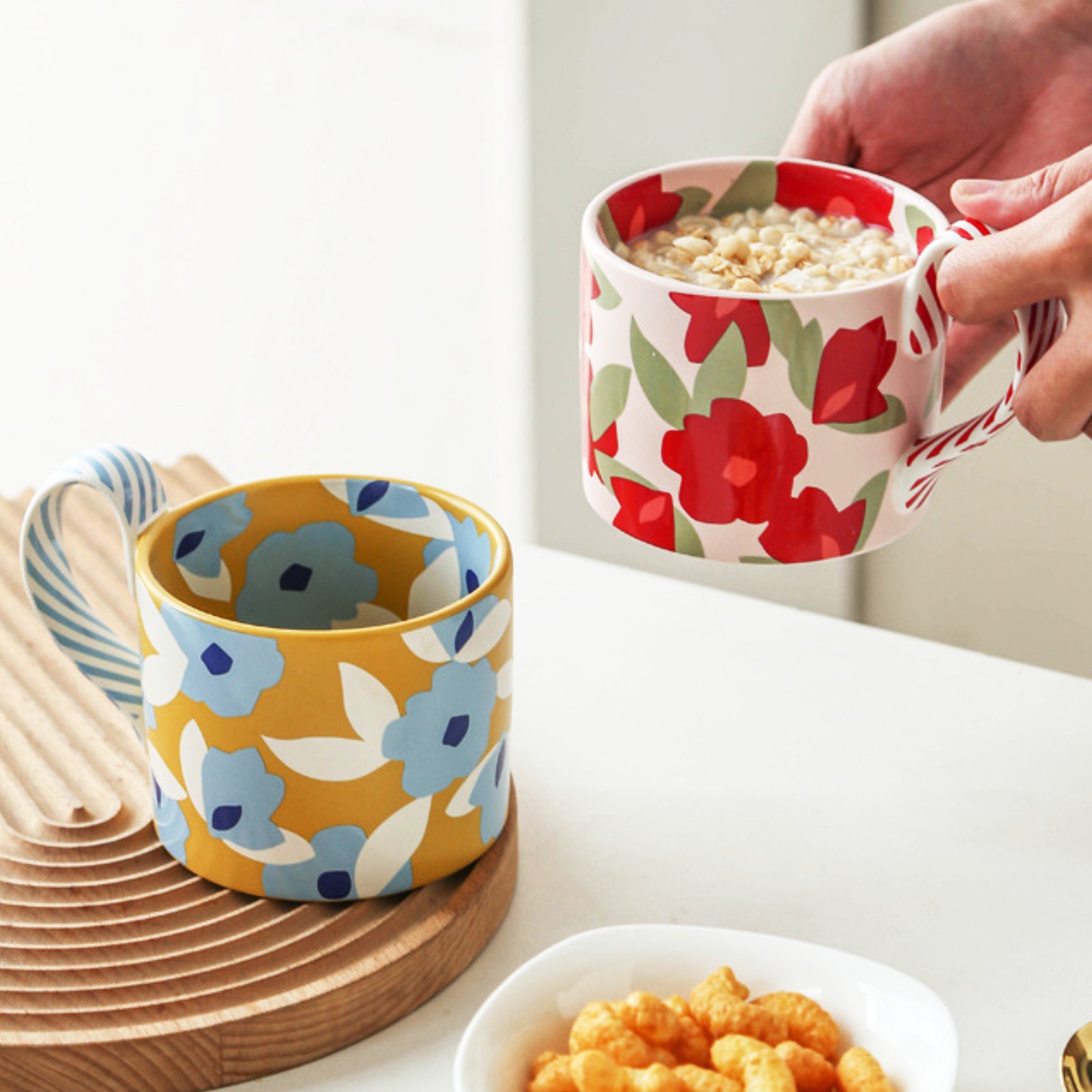 Vibrant Floral Ceramic Mug with Playful Striped Handle