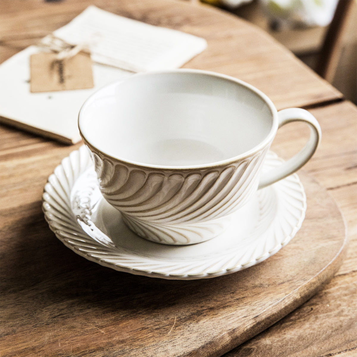 Elegant White and Cream Swirl-Pattern Coffee Cup with Matching Saucer