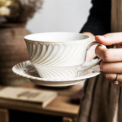 Elegant White and Cream Swirl-Pattern Coffee Cup with Matching Saucer